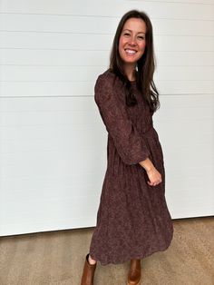 Embrace elegance with the Olivia Long Sleeve Floral Maxi Dress. This stunning maxi-length dress features a sweetheart illusion neckline + sheer balloon sleeves with gathered elastic cuffs, creating a chic + sophisticated look. The shirring along the bodice + waist ensures a flattering fit, while the tiered skirt adds a graceful, flowy silhouette. The chic + feminine floral print is perfect for any occasion, while the keyhole back adds a playful touch. Whether you're attending a wedding or a spec Brown Flowy Long Sleeve Midi Dress, Flowy Long Sleeve Brown Midi Dress, Brown Printed Long Sleeve Maxi Dress, Brown Long Sleeve Boho Print Dress, Long Sleeve Floral Maxi Dress, Brown Floral Print V-neck Maxi Dress, Illusion Neckline, Floral Maxi, The Chic