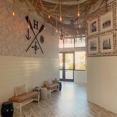 the inside of a building with wood flooring and white walls, decorated with nautical themed wallpaper