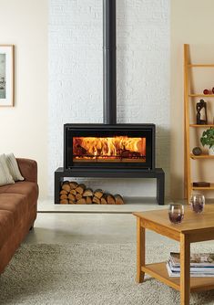 a living room filled with furniture and a fire place in the middle of the room