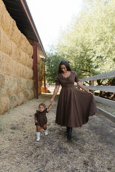 Brown and black plaid woven fabric Boat neckline with collar and functional drawstring bow Half length puff sleeve with elastic closure Midi length skirt with pockets Hidden back zipper Bodice and skirt lined Non-stretch fabric matching mommy and me style with styles for the whole family flowy floral dresses, earthy tones, vintage-inspired layers, cottagecore accessories, soft autumn hues, cottagecore dress, fall dress, fall fashion, family photo, gingham, brown dress European Wardrobe, Cottagecore Accessories, Autumn Cottagecore, Maple Dress, Brown Gingham, Fabric Matching, Flowy Floral Dress, Drawstring Neckline, Fashion Family