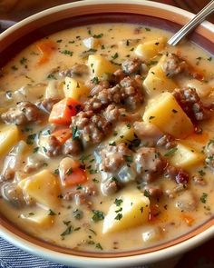 a bowl of soup with meat, potatoes and parmesan cheese in it on a blue cloth