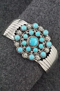 This stunning turquoise and bright-polish sterling silver bracelet was made by Navajo silversmith Jeremy Delgarito. The back is signed J Delgarito and stamped sterling.Size: 5 3/4" (will fit up to a 6 3/4" wrist)Gap: 1"Width: 1 5/8"Free shipping on all orders! We ship with USPS and always include tracking. All orders ship within a day of payment.Returns are accepted up to 30 days after you receive your order. Just send us a message. Our shop offers cash back or store credit. The item must be returned in new condition. Western Style Blue Bangle Jewelry, Western Style Blue Sterling Silver Bracelet Gift, Southwestern Sterling Silver Cuff Bracelet In Blue, Southwestern Style Turquoise Bracelet Stamped 925, Southwestern Style Round Turquoise Cuff Bracelet, Southwestern Style Turquoise Cuff Bracelet, Elegant Turquoise Concho Jewelry, Elegant Blue Jewelry With Concho Detail, Elegant Blue Concho Jewelry