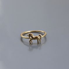 14K Gold Horse Ring:  This chic and minimal ring stacks perfectly with others or makes a statement on its own. It is a great gift for birthdays, Valentine's day, or any special occasion.  Materials & Specifications: - 14K gold - Available in 3 options: Yellow Gold, White Gold, and Rose Gold  - Horse dimensions are 1.1cm x 7.7mm Please note that all of our rose gold and white gold items are made with real rose and white gold. We do not plate any of our gold items.  As with all of our products, th Ring Stacks, Horse Ring, Gold Items, Ring Minimal, Gold Horse, Minimal Ring, Real Rose, Jewelry Show, Stackable Ring