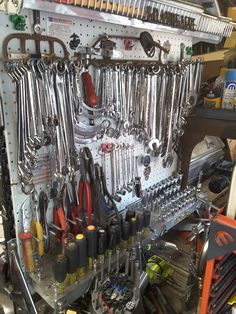 there are many tools hanging on the wall