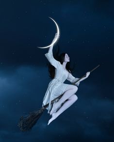 a woman flying through the air on top of a broom in front of a night sky