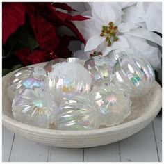 white glass ornaments in a bowl on a table