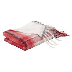 the red and white plaid blanket is folded on top of each other with fringes