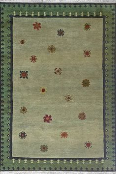 an area rug with many different colored flowers on the ground and green border around it