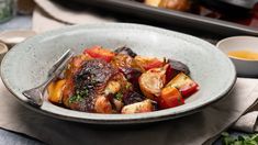 a bowl filled with cooked vegetables on top of a table