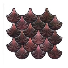 a group of pink scallop shells sitting on top of a white surface in the shape of a pyramid