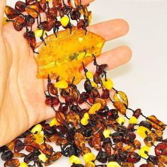 Necklace Stone(s): Genuine Baltic multi amber (honey amber slice measures 2.25 x 1.7 inches) Necklace Length: 18 inches Deep: 7.25 inches Weight: 78.6 grams Clasp: Amber Button Stamp/Mark: N/A Origin: Poland Serial Number: n20307 Amber, an organic gemstone, is the fossilized sap of prehistoric trees which grew up to 50 million years ago. The stone has been used for jewelry since the time of Christ. The world's finest amber comes from the region around the Baltic sea. Prehistoric Trees, Dangle Necklace, Necklace Stone, Dangle Necklaces, Baltic Sea, Necklace Length, Stone Necklace, Poland, Necklace Lengths