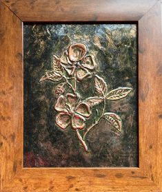 a close up of a painting in a wooden frame with flowers on the inside of it