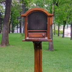 an old fashioned wooden radio in the middle of a park