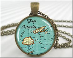 "This listing is for one round bronze plated map pendant resin charm featuring an old vintage map of the Fiji Islands Group. Great gift for those who love to travel. Includes a matching link chain necklace. * These beautiful picture pendants are made by me, in my home studio. * They are just over 1 inch in size(25mm). * Necklace lengths of 16, 18, 21 or 24 inches, or make request. * Pro quality printer used for the best reproduction possible. High detail level. * The pendants trays are a lead free zinc alloy casting. * Artwork is printed on the best high quality Canon photo paper. * The print is covered in glossy epoxy resin. * My pendants come gift wrapped. SHOP THE MG ARTISAN PENDANT STORE MGArtisanPendants.etsy.com 💗 Like this item? Don't forget to add it to your favorites (click the \ Fiji Map, Picture Jewelry, Fiji Islands, Map Pictures, Picture Pendant, Map Pendant, Map Necklace, Jewelry Picture, Resin Charms