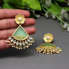 About these earrings: These are Amrapali-inspired Druzy Stone gold plated Earrings. It is finished with Kundan and pearls which makes it a unique piece to wear. One of the popular contemporary stone jewelry is Druzy Stone jewelry. This is one of the earrings, you should have in your collection. It's very versatile. This can be paired up with western dresses as well as ethnic too. Possibilities are limitless. Earring Length: 2.5Inch x Width: 1.75inch Metal: Brass With Good Quality Gold Plated Sto Handmade Green Chandbali Earrings, Bohemian Green Earrings For Wedding, Green Bohemian Earrings For Wedding, Handmade Green Chandelier Earrings For Celebration, Green Chandelier Earrings For Festivals And Gifts, Green Dangle Chandelier Earrings With Meenakari, Handmade Green Drop Earrings Danglers, Handmade Green Drop Earrings, Handmade Green Drop Danglers