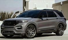 the new ford explorer is parked in front of a building