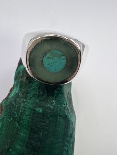 Designed and crafted by the owners and operators of The Miner's Emporium Jewelry Store Located in Rocky Mount, NC. This sterling silver man's ring was was handmade by Scot Slep. This unique ring contains custom cut inlaid jade and turquoise.  *Gift Ideas* This gorgeous ring is the perfect gift for any special occasion, or just because! *Unique Piece* This item is a unique creation, so once stock is gone, it's gone! *Sizing Options* This ring is available to be sized by the jewelers at the Miner's Emporium. [Sizing Down] - $35.00 [Sizing Up] - $35.00 for first size up, $10.00 per additional size up. *Specifications* [Band Material] - Sterling Silver [Gemstone] - Turquoise, Jade [Total Ring Weight] - 16.3 Grams [Finger Size] - 9.5  *We Appreciate You!* By supporting this shop, you are suppor Modern Round Cabochon Emerald Ring, Turquoise Inlay Round Rings, Artisan Turquoise Opal Ring, Modern Emerald Cabochon Rings, Modern Green Cabochon Rings, Modern Turquoise Ring With Polished Finish, Polished Chrysoprase Ring Jewelry, Green Malachite Rings With Polished Finish, Green Turquoise Ring With Natural Stones