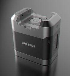 an image of a digital camera on a black surface with the words samsung printed on it