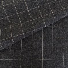 the fabric is made up of grey and black checkerboard pattern, with white stitching