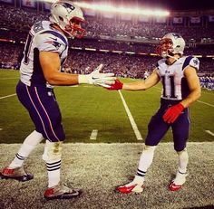 two football players shaking hands on the field