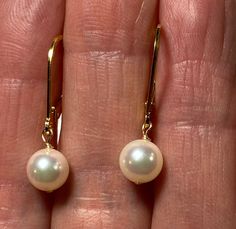 Please look carefully at the photos.  I take close-up pictures to show details, but have measurements and items to show scale. This is a classic dangle pearl earring on gold-filled lever backs.  These 6.5mm AA quality (in house grading) Japanese Akoya pearls are round to near round.  The color is white to warm white with secondary pink and green hues.  The nacre is medium thick and un-blemished with a lovely, bright luster.  These pearls are on gold-filled head pins and lever back ear wires for Classic Round Pearl Earrings With French Hook, Classic Pearl Earrings With French Hook For Anniversary, Classic Round Earrings With French Hook, Classic Round French Hook Earrings, Classic French Hook Earrings, Classic Pearl Earrings With French Hook For Formal Occasions, Classic Formal Earrings With Ear Wire, Classic French Hook Earrings For Anniversary, Classic Teardrop Pearl Earrings With French Hook