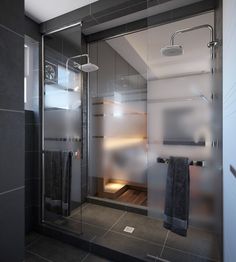 a bathroom with a walk in shower next to a tiled floor and gray tile walls