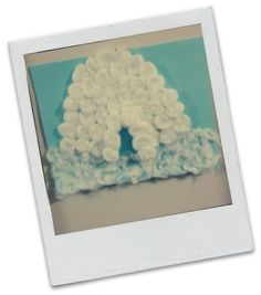 a polaroid photo of a cake with white frosting