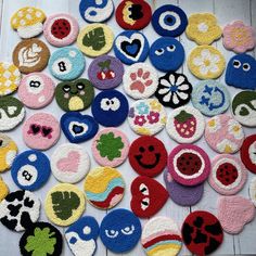 many different colored buttons with faces on them