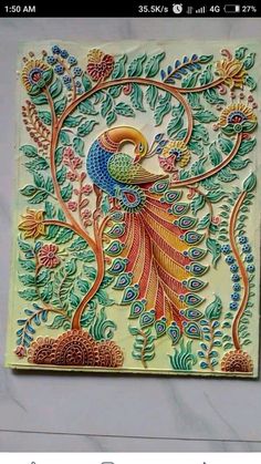 an intricately painted tile with peacocks and flowers