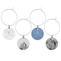 four wine glass charms with the same photo on them, one has a bow and two are