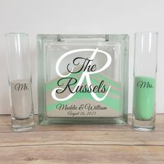 two shot glasses, one with the bride and groom's initials