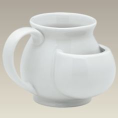 a white cup with a handle on the side and a smaller one in the middle