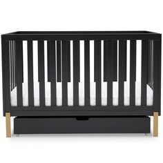 a black crib with white sheets and gold trim on the bottom half, in front of a white background