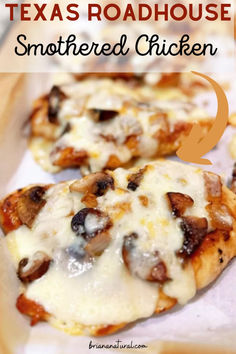 two small pizzas sitting on top of a wooden cutting board