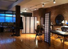 a room with wooden floors and large windows