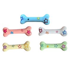 four bone shaped dog toys with stars on them