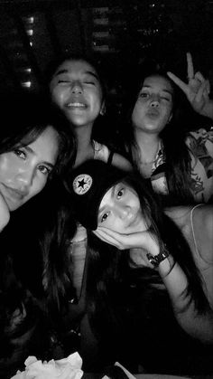 four girls are posing for the camera in black and white