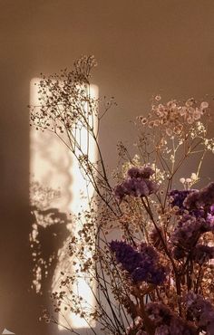 a vase filled with lots of purple flowers