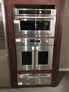 an oven built into the side of a cabinet in a kitchen with stainless steel appliances