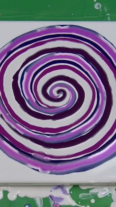 a purple and white plate with swirl designs on it