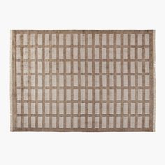 an area rug with squares and lines on the side, in neutral colors against a white background