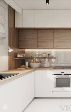 a kitchen with white cabinets and wooden counter tops