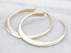 Achieve a classic look in a modern way with these yellow-gold hoop earrings. These shiny, statement-making earrings make a subtle statement with their elegant, yet timeless flat shape. Metal: 14K Yellow GoldMeasurements: 3 x 33 mmMarks: "14K" Stamped on the inside Modern Hammered Hoop Earrings For Formal Events, Modern Hammered Hoop Earrings For Formal Occasions, Modern Tarnish-resistant Hoop Earrings For Wedding, Modern Hoop Earrings For Wedding, Modern Small Hoop Earrings For Wedding, Modern Wedding Hoop Earrings With Polished Finish, Small Hammered Hoop Earrings For Formal Occasions, Hammered Hoop Earrings For Anniversary, Elegant Hammered Hoop Earrings For Anniversary