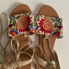 Never Worn. Flat Sandals With Suede (?) “Laces”. Size Us 8 (Noted As 6 For U.K. Measurements). Beige Sandals For Spring Festival, Embroidered Open Toe Sandals For Summer, Embroidered Open Toe Sandals For Festival, Multicolor Embroidered Open Toe Sandals For Summer, Vacation Sandals With Floral Embroidery And Open Toe, Embroidered Open Toe Sandals For Spring, Embroidered Flat Sandals For Summer, Embroidered Festival Sandals For Spring, Embroidered Sandals For Spring Vacation