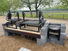 an outdoor table made out of cinder blocks with wheels attached to the top and sides