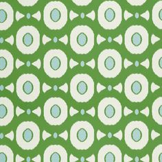 a green and white pattern with blue dots