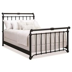 a black metal bed frame with white linens and pillows on the bottom, in front of a white background