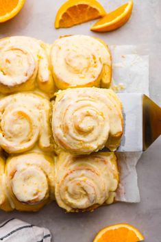 orange rolls with frosting and sliced oranges