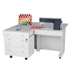 a desk with a computer, printer and colored bottles on it's top shelf