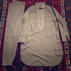 Brand New, Never Worn, 2 Piece Men's Outfit. The Color Is A Purplish-Grey. Has A Nice Embroidered Collar And Chest. Also Has Two Pockets. Chest Is 21in And Length Is 37in. Has Some White Marks On Shirt, Should Come Out If Washed. Made In Afghanistan Fitted Cotton Traditional Wear For Semi-formal Occasions, Fitted Cotton Semi-formal Traditional Wear, Traditional Gray Kurta For Eid, Gray Traditional Wear For Eid, Traditional Gray Wear For Eid, Gray Traditional Sets With Chikankari Embroidery, Classic Unstitched Cotton Lawn Suit, Traditional Gray Chikankari Embroidery Sets, Gray Chikankari Embroidery Traditional Sets